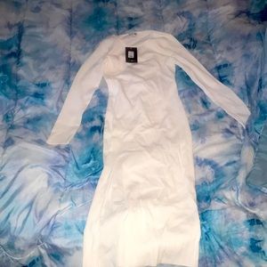 White long sleeve dress with slit.